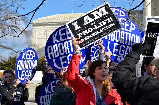 Washington D.C., USA - January 22, 2015; A Pro-Life woman clashes with a group of Pro-Choice demonstrators at the U.S. Supreme Court. 