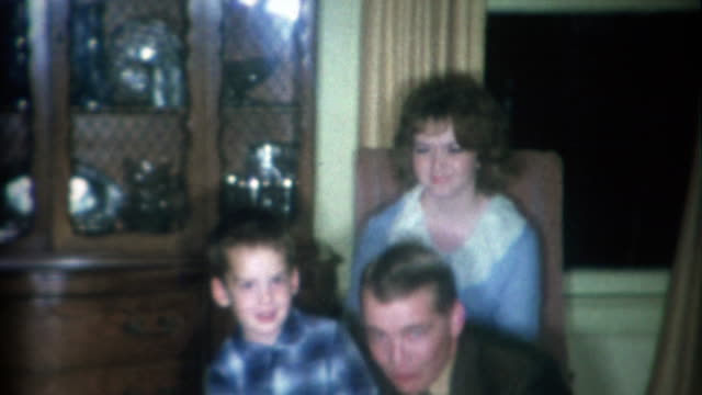 1966: Loud and brash dad smoking cigarette near boy and mother.