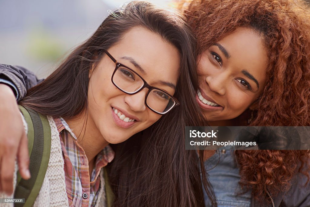 Best friends for life Cropped shot of girlfriends bonding on campus 2015 Stock Photo