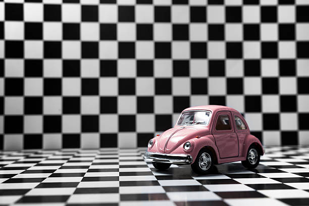 Izmir, Turkey - January 24, 2015: Toy Volkswagen Beetle on checkered background,illustrative editorial.Shoot date and location:Izmir, Turkey - January 24, 2015