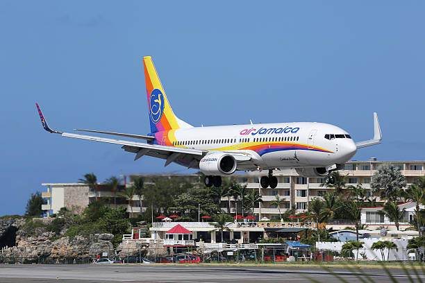 St. Martin, Netherlands Antilles - February 8, 2014: An Air Jamaica Boeing 737-800 with the registration 9Y-JMB approaching St. Martin Airport (SXM). St. Martin is rated one of the most dangerous airports in the world. Air Jamaica is the national airline of Jamaica with its headquarters in Kingston.