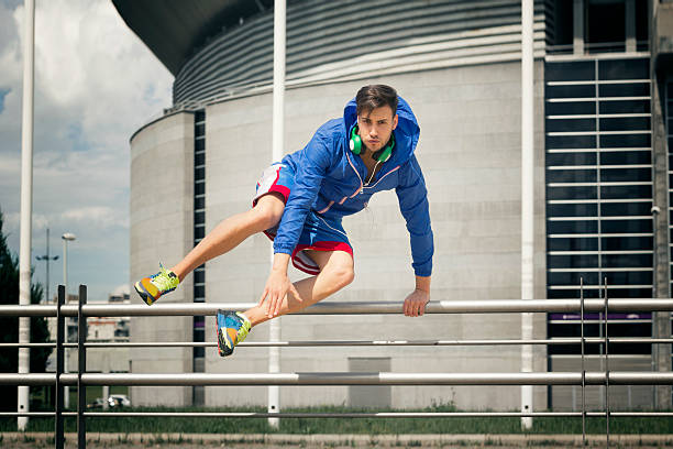 красивый молодой спортсмен прыжки через забор - over the fence стоковые фото и изображения