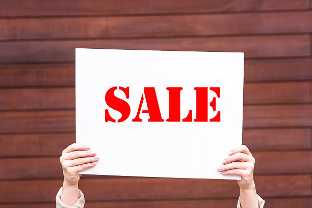 istock woman holding a sale sign 534476784