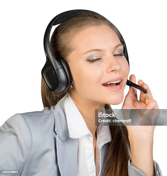 Businesswoman In Headset With Her Fingers On Microphone Boom Stock Photo - Download Image Now