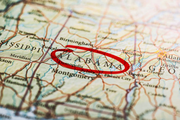 Alabama Marked on Map Alabama circled with red marker on map. Close up shot. alabama us state stock pictures, royalty-free photos & images