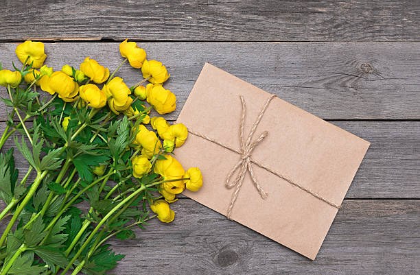 istock Yellow flowers on a wooden background 534478952