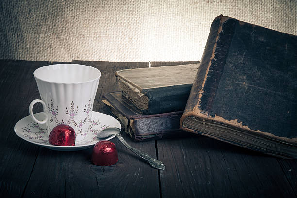 istock Cup of coffee, shokolad and stack of old books 534480981