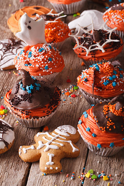istock festive Halloween cupcakes and gingerbread cookies closeup 534481300