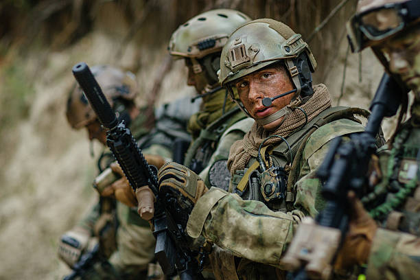 istock soldier holding a gun and looking at viewer 534481455