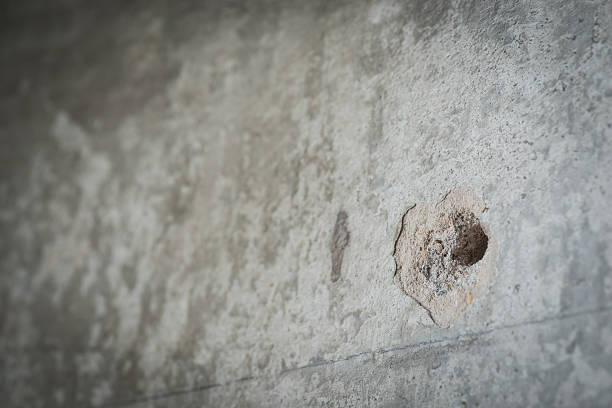 istock Drilled hole in a grey concrete wall 534482260