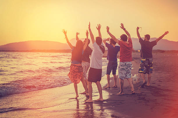 istock group of friends enjoying sunset on the beach 534483872