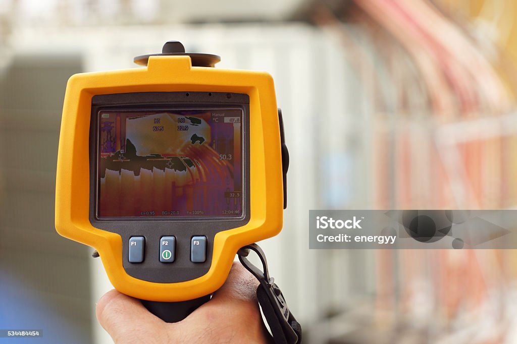 Infrared Thermal Imaging Camera Pointing to Electrical Transformer Thermal Image Stock Photo