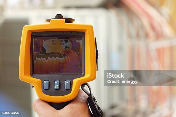 Infrared Thermal Imaging Camera Pointing To Electrical Transformer Stock Photo - Download Image Now