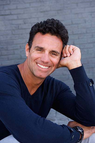 istock Handsome older man smiling with blue sweater 534484524