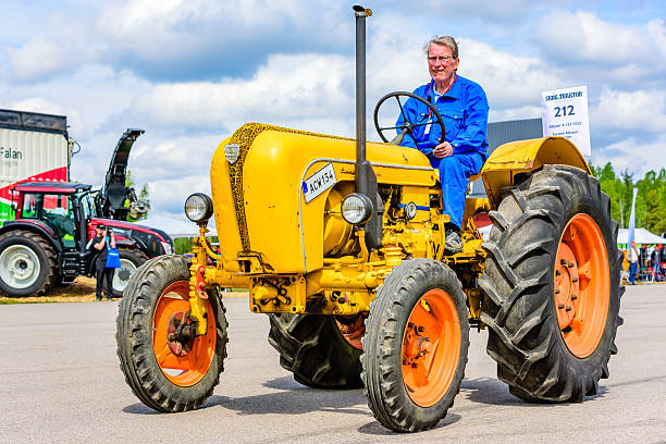 Emmaboda, Sweden - May 14, 2016: Forest and tractor (Skog och traktor) fair. Vintage classic tractors on parade. Here a yellow 1953 Allgaier A 133.