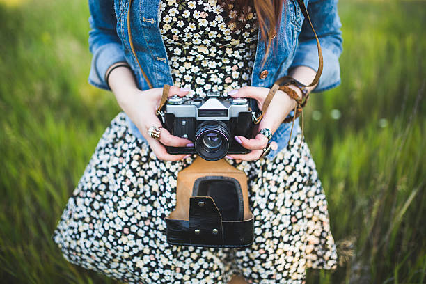istock Girl with old camera on the maedow 534494674