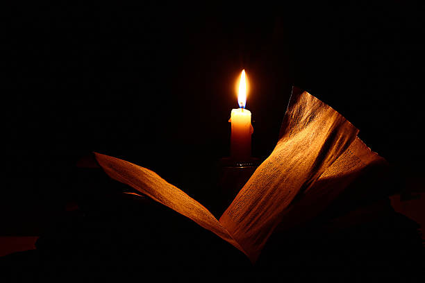 istock concept of knowledge, vintage book candle 534501753