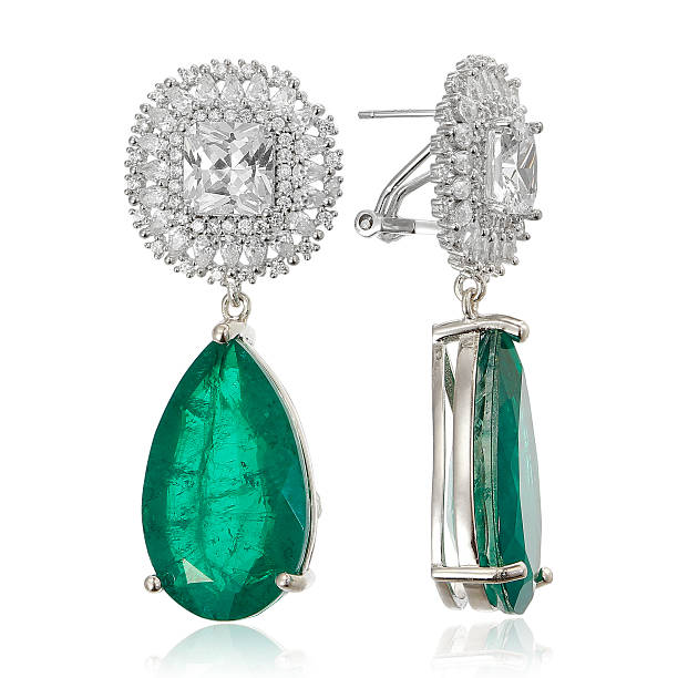 istock Gold earrings with emeralds isolated on white 534502548