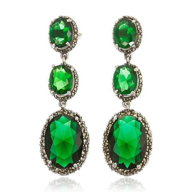 istock Silver earrings with emeralds isolated on white 534502846