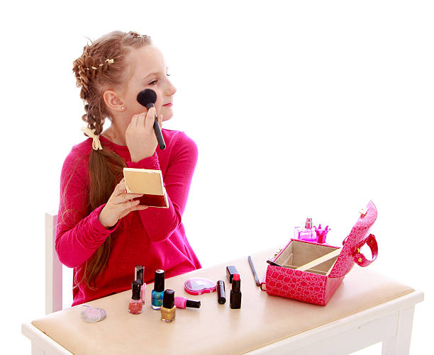 istock Little girl doing make-up sitting at the table 534504057