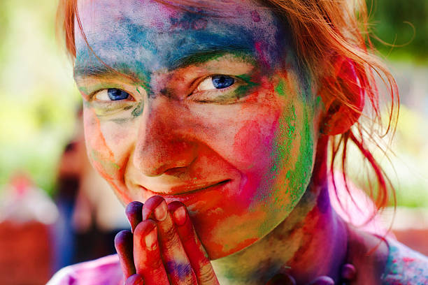 European girl celebrate festival Holi in Delhi, India. Holi, or Holli,is a spring festival celebrated by Hindus, Sikhs and others. The main day, Holi, is celebrated by people throwing coloured powder and coloured water at each other.