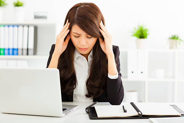 istock stressed  businesswoman sitting in office 534510003