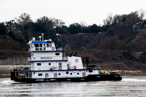 Tugboat traveling down the Mississippi river