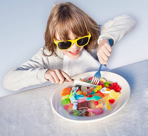 Eating gum candy The dream of a child is to get gum candy to eat. With this humoristic image you can illustrate a lot of current issues. pick and mix stock pictures, royalty-free photos & images