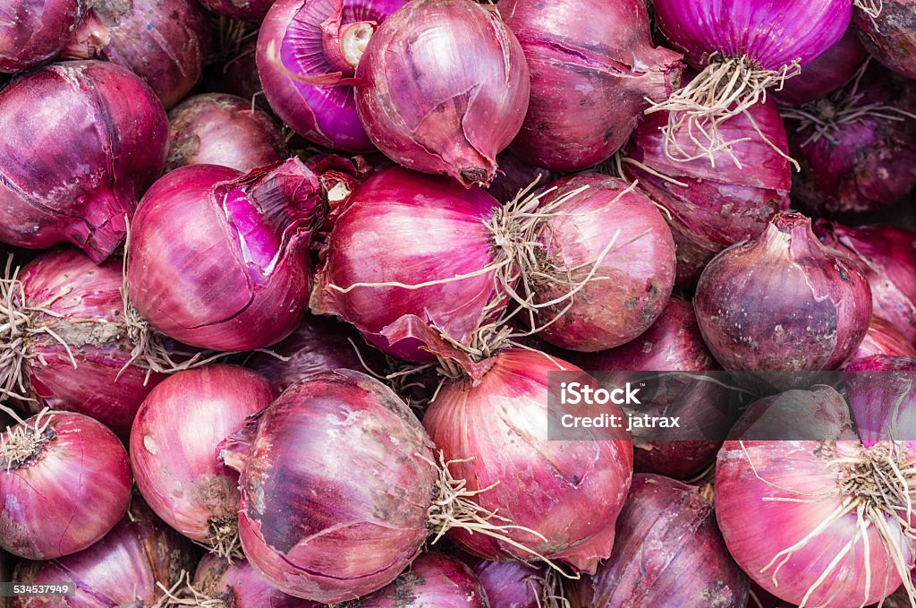 Harvested red onions on display Freshly harvested red onions on display at the market 2015 Stock Photo