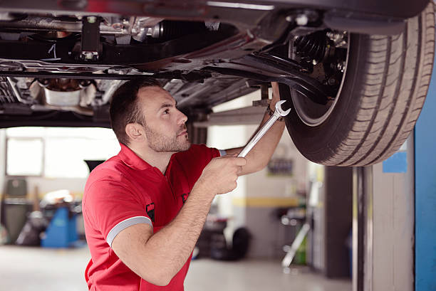 mechanic with tool checking the car portrait of mechanic with tool checking the car shock absorber stock pictures, royalty-free photos & images