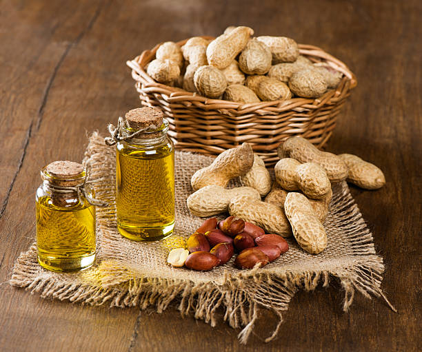 istock peanut oil and nuts on a wooden table 534540295