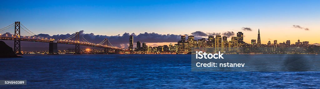 Bay Bridge and San Francisco Evening panorama of San Francisco and Bay Bridge taken from Treasure Island. Urban Skyline Stock Photo