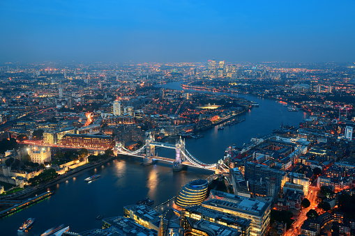 London aerial view panorama at night with urban architectures and Tower Bridge.