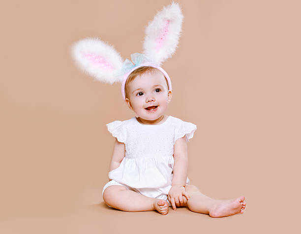 istock Charming baby sitting in costume easter bunny 534542033