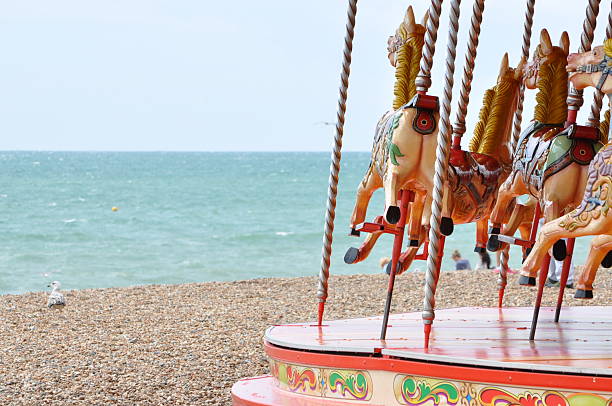пляж carousel - architectural styles animal horse europe стоковые фото и изображения
