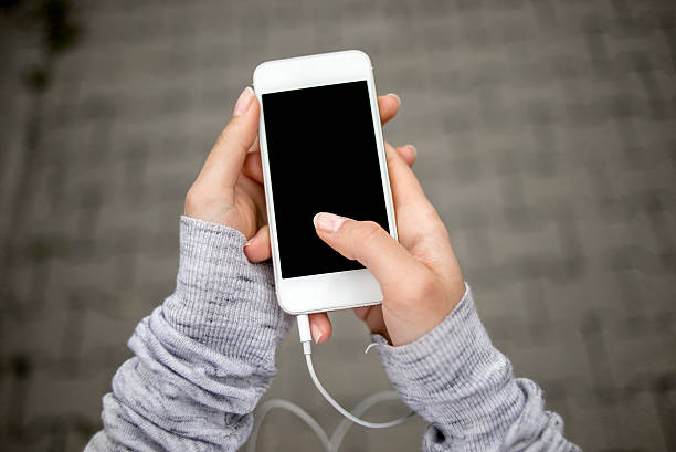 Young woman using smartphone Young woman using smartphone  (first person view) personal perspective standing stock pictures, royalty-free photos & images