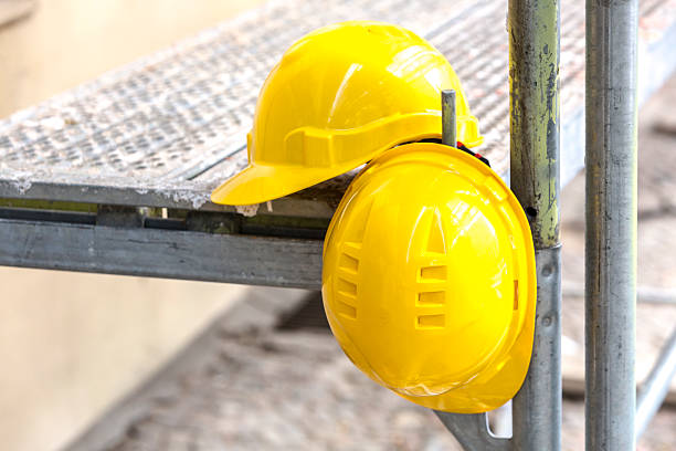istock Two yellow hardhats on scaffolding 534547412