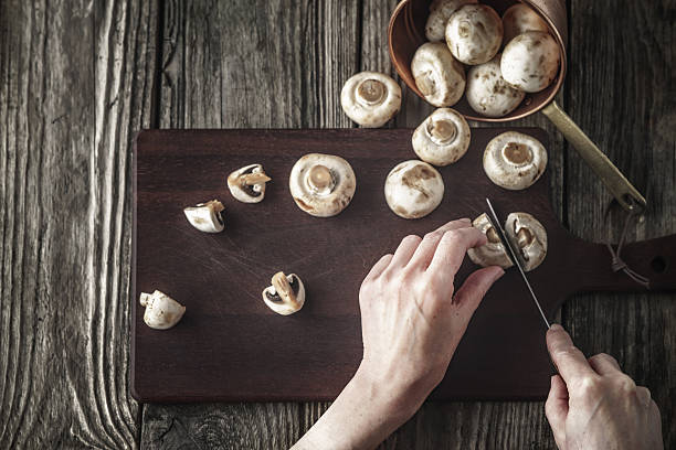 istock Cutting mushrooms on the wooden board top view 534552122