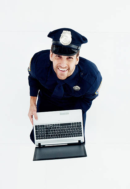 istock Cheerful police holding laptop 534553904