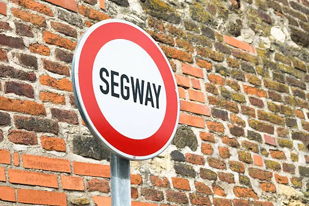 The segway sign and the brick wall