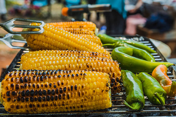 istock Corn and green chili pepper are cooked on the grill 534554612