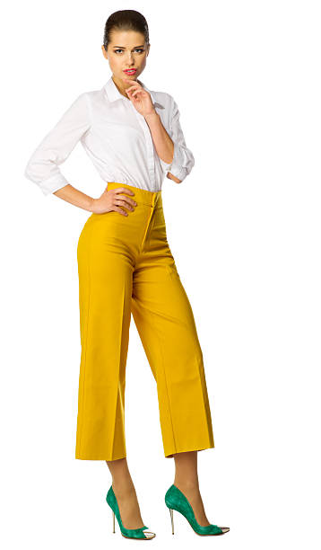 istock Young woman in yellow pants isolated 534554988