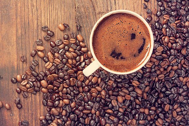istock Cup of coffee on wooden table 534556400