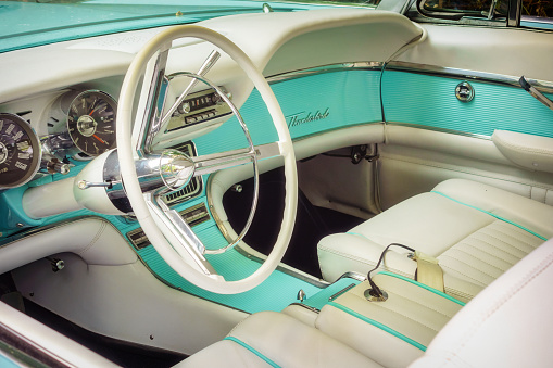 Toronto, Canada - August 31, 2013: Interior view of a 1962 Ford Thunderbird with steering wheel, dashboard and leather seats.