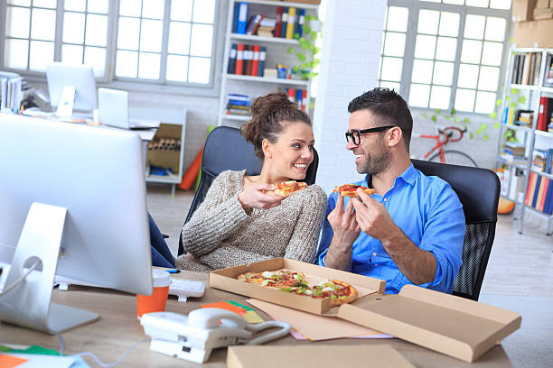 istock Hungry colleagues having lunch break at workplace 534568088