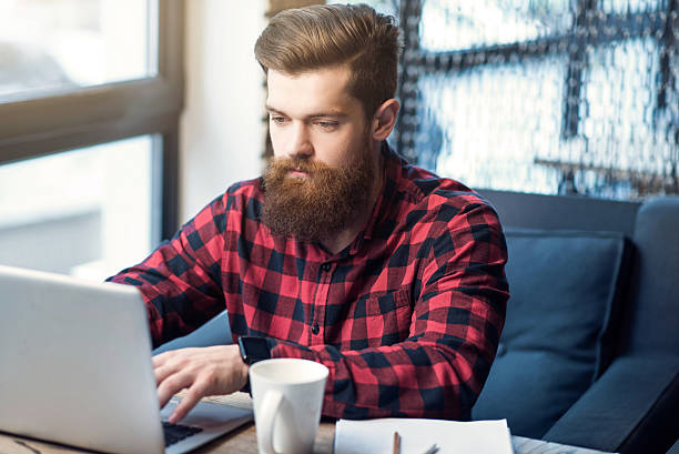 istock Brutal  bearded man sitting at the table 534569976