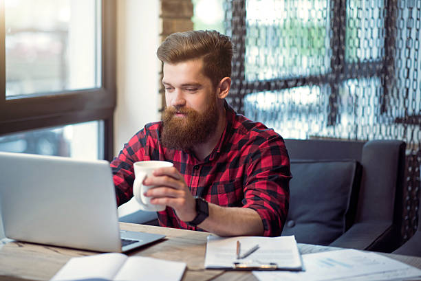 istock Cheerful  bearded man sitting at the table 534570048