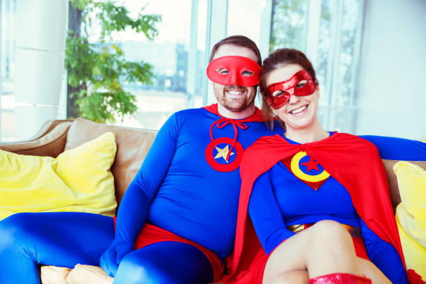 istock Superhero couple smiling on living room sofa 534573783