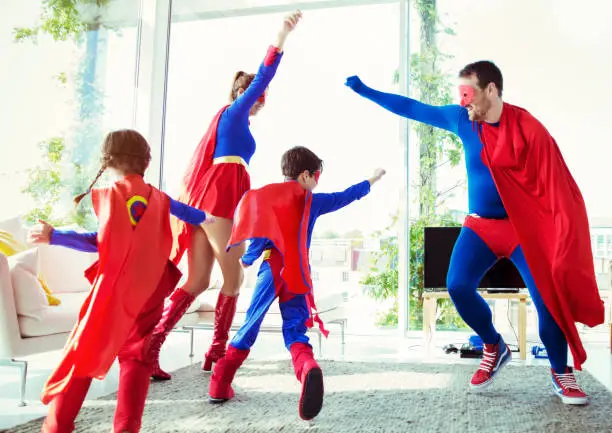 Photo of Superhero family playing in living room