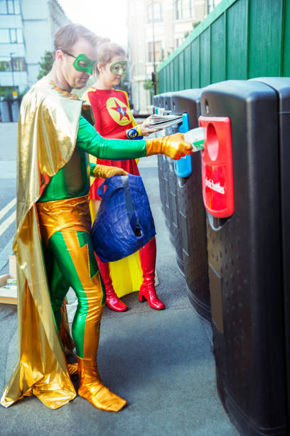 istock Superhero couple recycling on city sidewalk 534573987